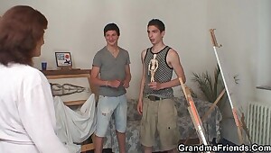 Naughty granny takes two young dicks